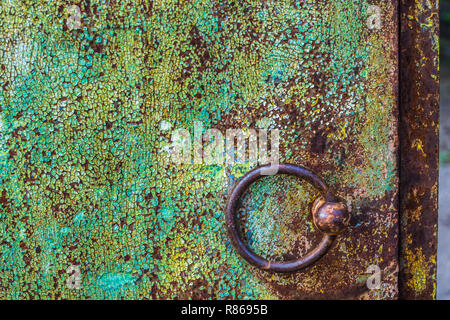 round iron brown door knob on the green shabby wall. Stock Photo