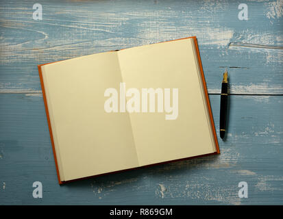 open book with blank pages on wooden table - closeup Stock Photo