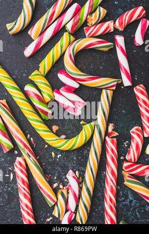 High angle view of a broken candy cane on dark background. Stock Photo