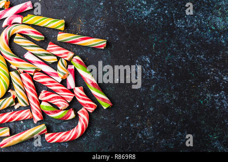 High angle view of a broken candy cane on dark background. Stock Photo