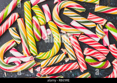 High angle view of a broken candy cane on dark background. Stock Photo