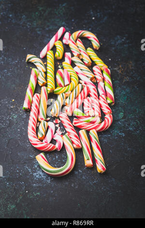 High angle view of a broken candy cane on dark background. Stock Photo