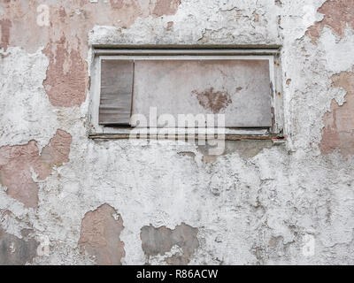 Boarded up window in old building wall. Stock Photo