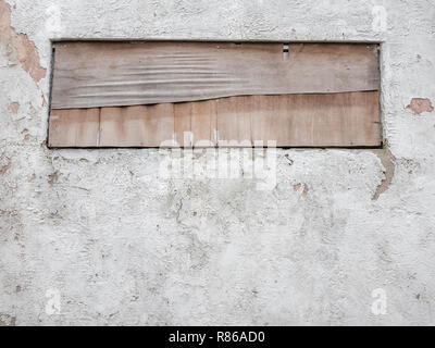 Boarded up window in old building wall. Stock Photo