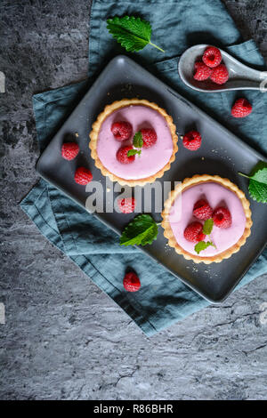 Sweet tartlets filled with raspberry mascarpone cream Stock Photo