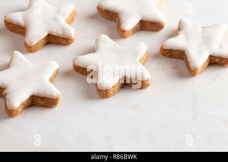 A Batch of Star Shaped Gingerbread Cookies with White Icing Stock Photo