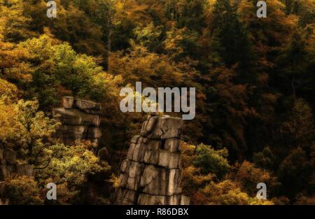 Canyon with bizarre rock formation and colored trees in autumn seen from the Hexentanzplatz in Germany, Harz Mountains Stock Photo