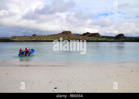 Tourist dinghy motoring between Chinese Hat and Santiago islands, Galapagos National Park, Ecuador. Stock Photo