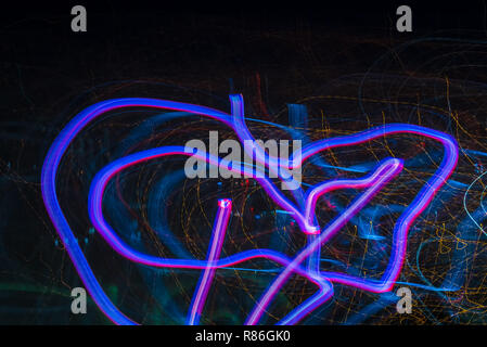 Bright abstract spiral patterns from colored light strips on a black background Stock Photo