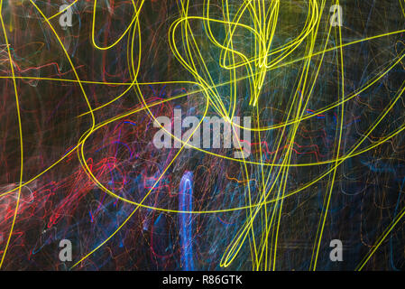 Bright abstract spiral patterns from colored light strips on a black background Stock Photo