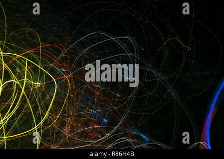 Bright abstract spiral patterns from colored light strips on a black background Stock Photo