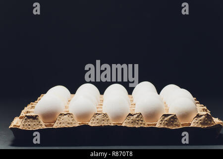 Several white eggs in an egg carton. Stock Photo