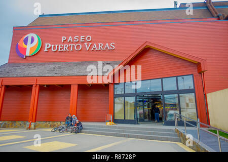 PUERTO VARAS, CHILE, SEPTEMBER, 23, 2018: Group of friends at the enter of paseo Puerto Varas, huge orange wooden building Chile, South America Stock Photo