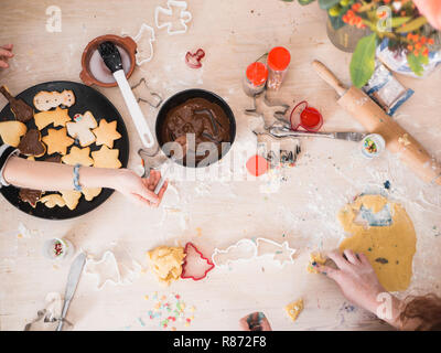 https://l450v.alamy.com/450v/r872f8/christmas-bakery-girls-preparing-christmas-cookies-top-view-with-sifferent-baking-supplies-chaotic-table-r872f8.jpg