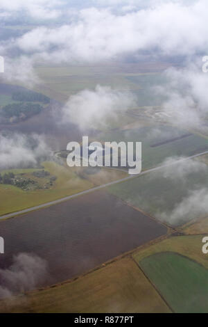 Aerial photo over foggy but green Swedish landscape near Stockholm on a November morning in Stockholm, Sweden. Stock Photo