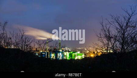 Oil refinery with vapor - petrochemical industry at night Stock Photo
