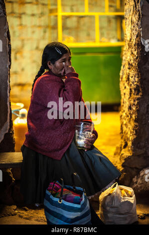 The woman is drinking chicha. Chicha- Inca beer is made from a special ...