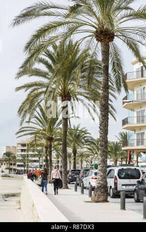 CAN PASTILLA, MALLORCA, SPAIN - NOVEMBER 23, 2018: Seaside promenade hotels with palms and people on November 23, 2018 in Palma de Mallorca, Spain. Stock Photo
