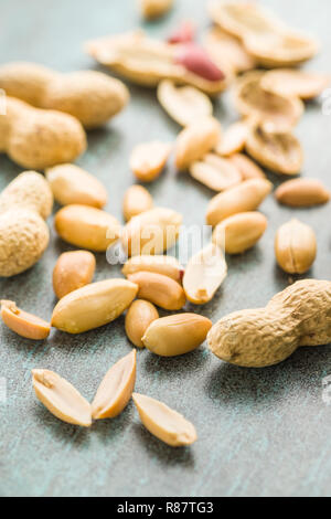 The dried peanuts. Groundnuts on old table. Stock Photo