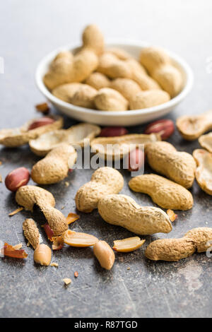 The dried peanuts. Groundnuts on old table. Stock Photo