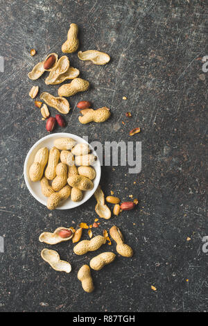The dried peanuts. Groundnuts on old table. Top view. Stock Photo