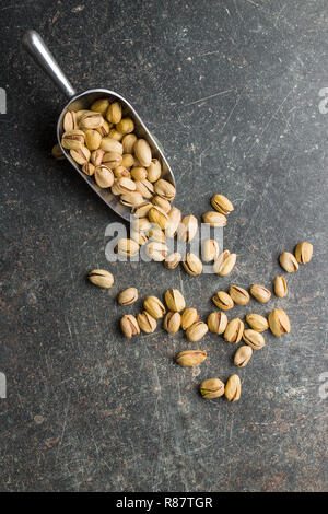 The pistachio nuts in scoop.  Top view. Stock Photo