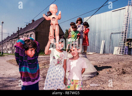 Gypsies children playing with dolls broken doll, Gypsy people, Ostrava Czech Republic Stock Photo