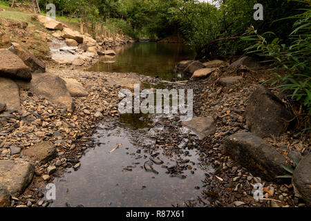 The waterfall flows through the rocks into small streams at Pong river Chanthaburi Thailand. Stock Photo