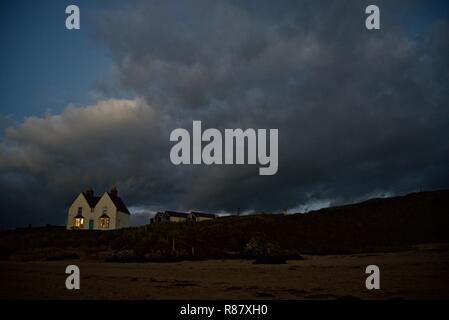 A beachfront victorian house at night in the seaside village of Rhosneigr, Anglesey, North Wales, UK Stock Photo