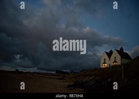 A beachfront victorian house at night in the seaside village of Rhosneigr, Anglesey, North Wales, UK Stock Photo