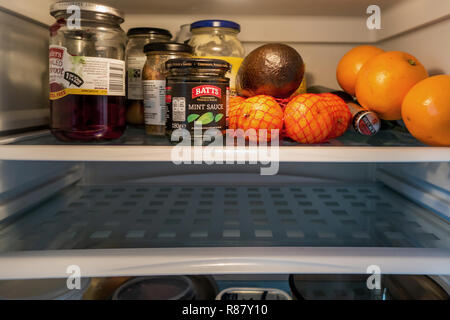 The inside shelf of a Fridge and the contents and one empty shelf that are owned by an 90 year old lady in England Stock Photo