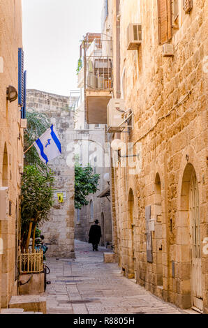 Ultra Orthodox Jewish man walking down a road in the Jewish Quarter of the Old City in Jerusalem, Israel Stock Photo