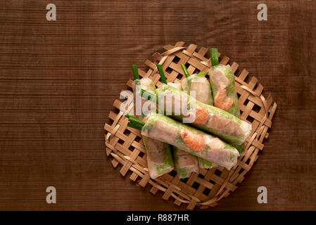 Vietnamese spring rolls - rice paper, lettuce, salad, vermicelli, noodles, shrimps, fish sauce, sweet chili, soy, lemon, veletables. Copy space. Asian Stock Photo