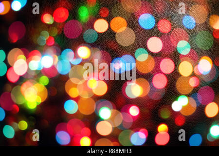 Colourful festive multi-colored circles . Defocused abstract multicolored bokeh lights background.Rainbow bokeh effect.Holiday postcard.Festive Winter wallpaper background. Stock Photo