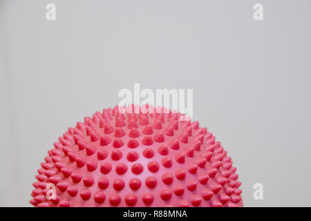 Spiky massage ball isolated on the white background.Flat feet correction exercise.half balance massage balls. rubber ball for self massage, reflexology and myofascial release.therapeutic exercise.Copy space Stock Photo