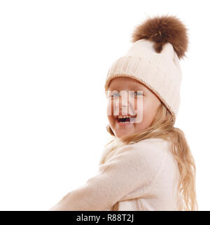 Portrait of a laughing little girl in a knitted hat with a pompon, scarf and sweater. Isolated on white background Stock Photo