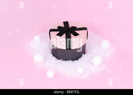 Gift box with ribbon on an pink background. Stock Photo