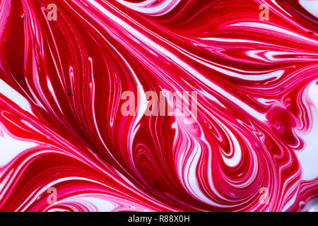 Colourful abstract background of red, white and pink swirl / swirls of liquid paint Stock Photo