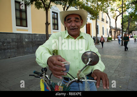 Male street vendor wearing cowboy hat selling refreshments in Bolivar Square, portrait, Caracas, Venezuela, South America Stock Photo