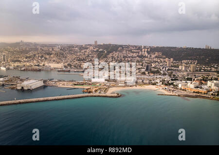 Haifa Beach, Israel, aerial view. Sunrise over the sea. The sun rises from the horizon. Top view of the seaside town of Haifa. The sea Port in Haifa. Stock Photo