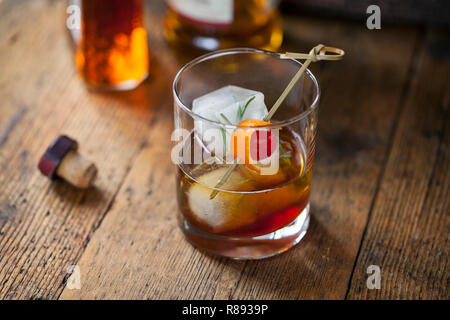 Old fashioned, whiskey drink with rosemary ice cubes Stock Photo