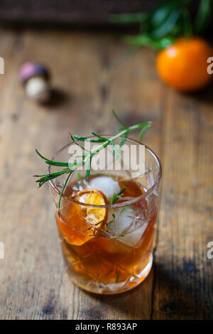 Old fashioned, whiskey drink with rosemary ice cubes Stock Photo