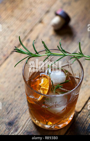 Old fashioned, whiskey drink with rosemary ice cubes Stock Photo