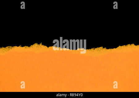 Yellow ripped paper isolated on black background with copy space Stock Photo