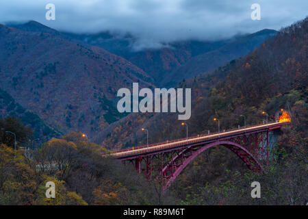 Beautiful red Mameyaki Bridge of country road among mountains in countryside in Saitama, Japan Stock Photo