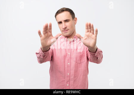 young casual man making stop with his hands Stock Photo