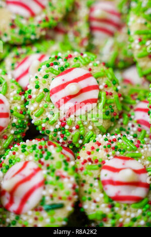 White chocolate peppermint kisses cookies decorated with Christmas holiday sprinkles and jimmies. Portrait orientation Stock Photo