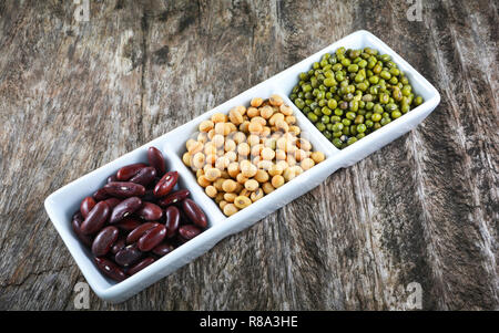 whole grains seeds various beans lentils with mung bean , soybean and red kidney bean -  cereal mix beans in cup on wood background Stock Photo