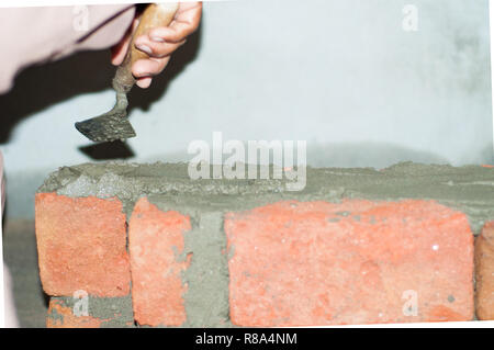 Working hand of a mason Stock Photo
