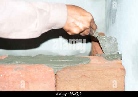 Working hand of mason Stock Photo
